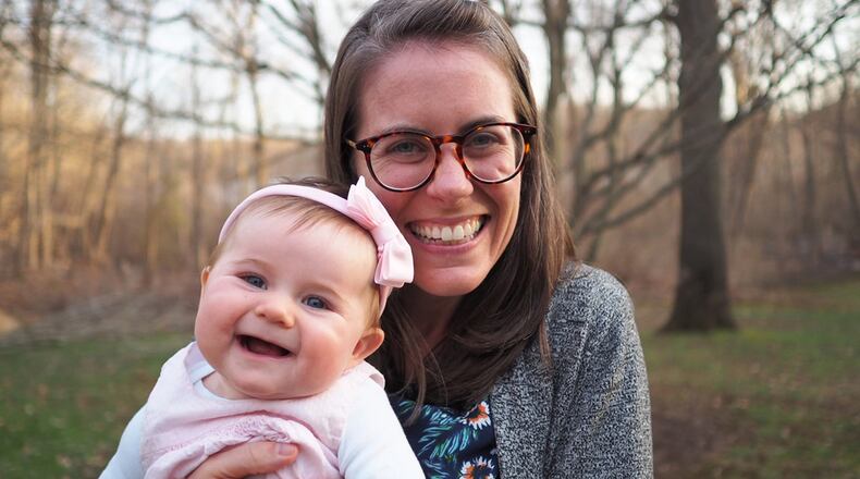 Nichole Mitchell, a nurse practitioner, holds her daughter, June. Mitchell says a residency program helped her develop a specialty in caring for patients with HIV and hepatitis C, as well as transgender care. (Courtesy of Nichole Mitchell)