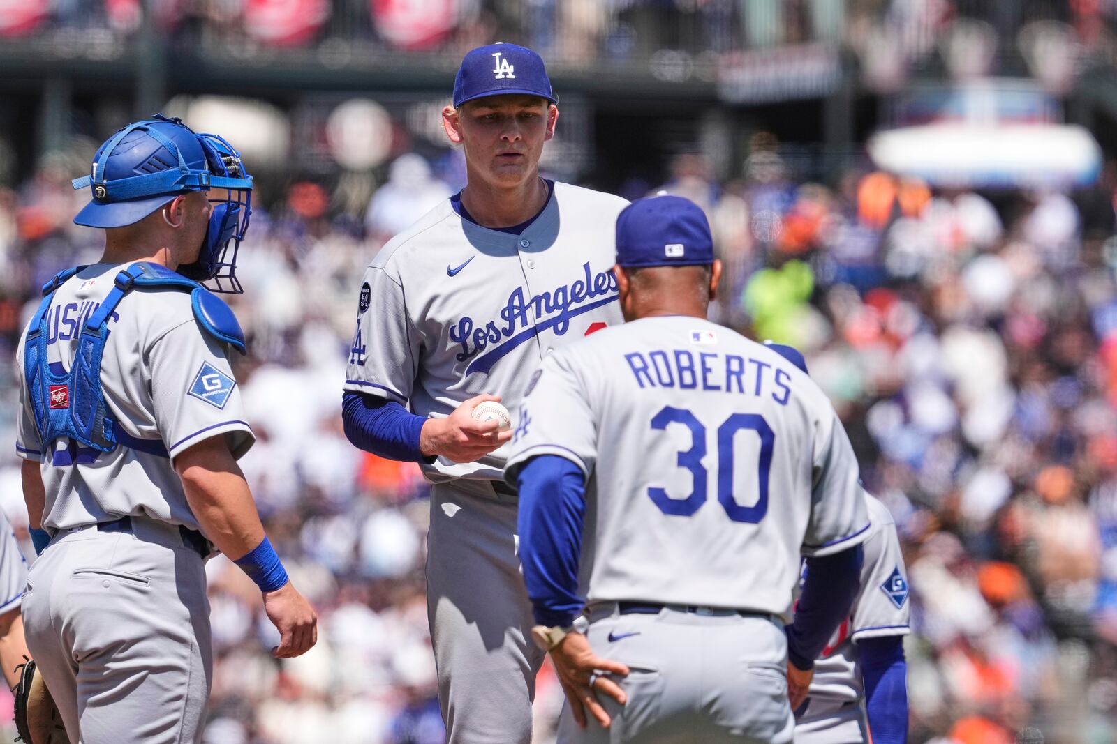 Los Angeles Dodgers pitcher Emmet Sheehan, center, hands the ball over to manager Dave Roberts as he exits during the eighth inning of a baseball game against the San Francisco Giants, Saturday, July 12, 2025, in San Francisco. (AP Photo/Godofredo A. Vásquez)