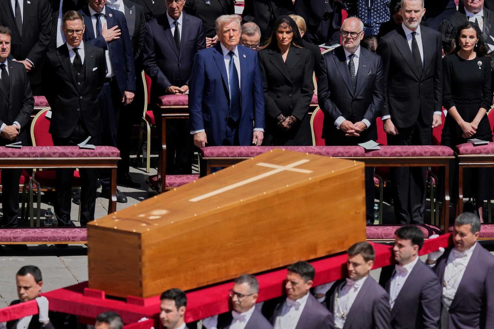 The coffin of Pope Francis is carried in front of dignitaries, including President Donald Trump, center, during his funeral in St. Peter's Square at the Vatican, Saturday, April 26, 2025. (AP Photo/Gregorio Borgia)