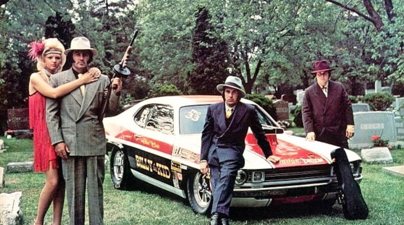 Bill Stepp, with engine builder Paul Frost, driver Stuart McDade and Cindy Cooper in a promotional photo for the race team. PHOTO BY DON GREEN