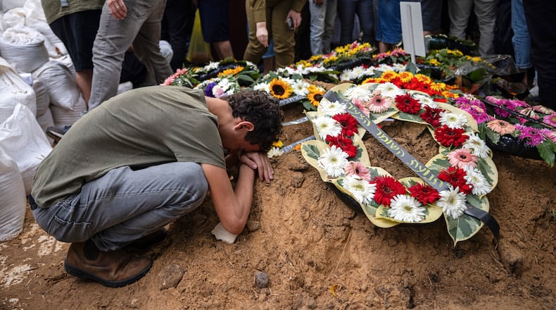 Mourners at the funeral of Col. Roi Levy, an Israeli soldier killed when Palestinian militants infiltrated Israel, in the Mount Herzl military cemetery in Jerusalem, Monday, Oct. 9, 2023. (Tamir Kalifa/The New York Times)