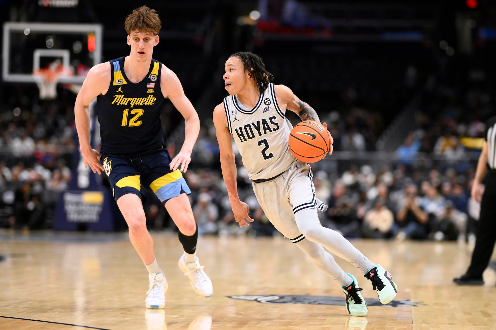 FILE - Georgetown guard Malik Mack (2) dribbles the ball next to Marquette forward Ben Gold (12) during the first half of an NCAA college basketball game, Saturday, March 1, 2025, in Washington. (AP Photo/Nick Wass, file)