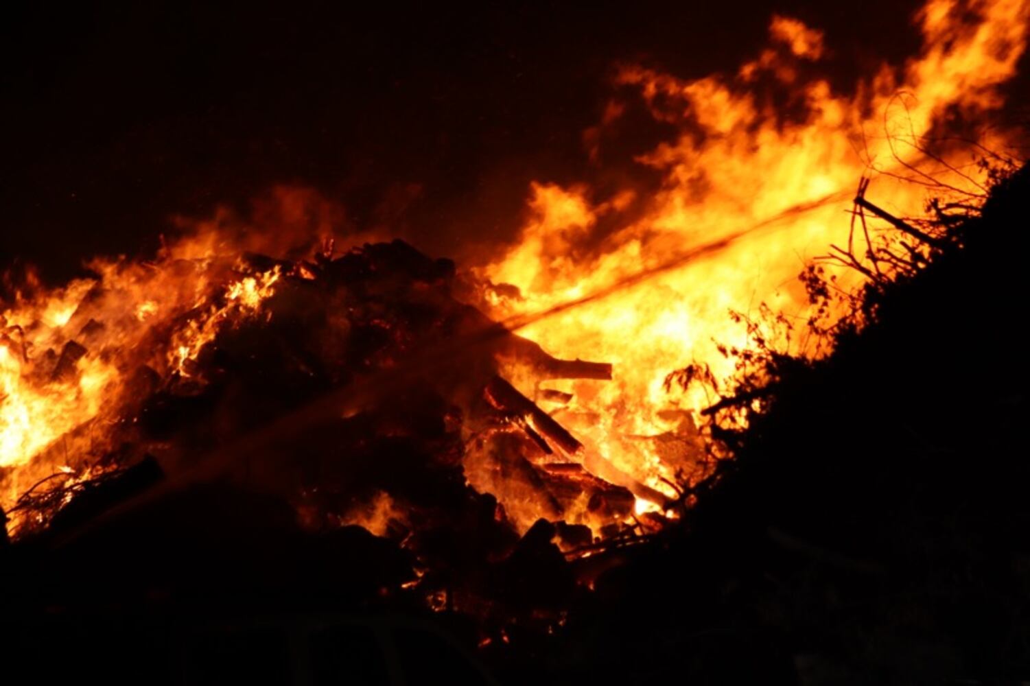 Fire crews battling huge fire in wood piles on Harshman Road