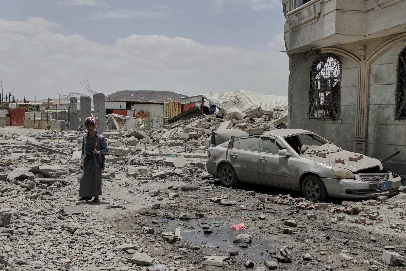 A Yemeni soldier inspects the damage reportedly caused by U.S. airstrikes in Sanaa, Yemen, Sunday, April 27, 2025. (AP Photo/Osamah Abdulrahman)