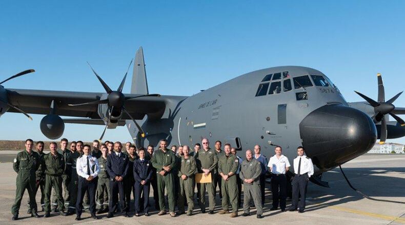 A group of Airmen from the Air Force Air Mobility Command and French Air Force pause for a photo in front of a KC-130J aircraft that was delivered to Évreux-Fauville Air Base, France Sept. 17. (Contributed photo)