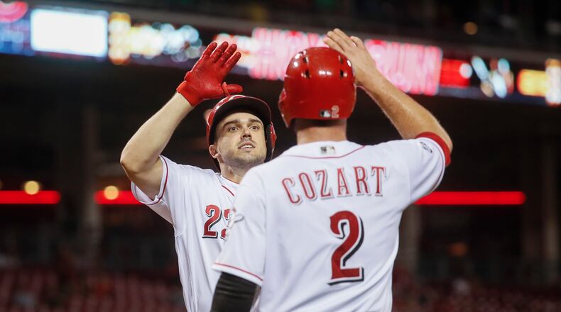 Cincinnati Reds' Adam Duvall, left, celebrates with Zack Cozart (2) after hitting a two-run home run off New York Mets pitcher Rafael Montero in the third inning of a baseball game, Tuesday, Sept. 6, 2016, in Cincinnati. (AP Photo/John Minchillo)