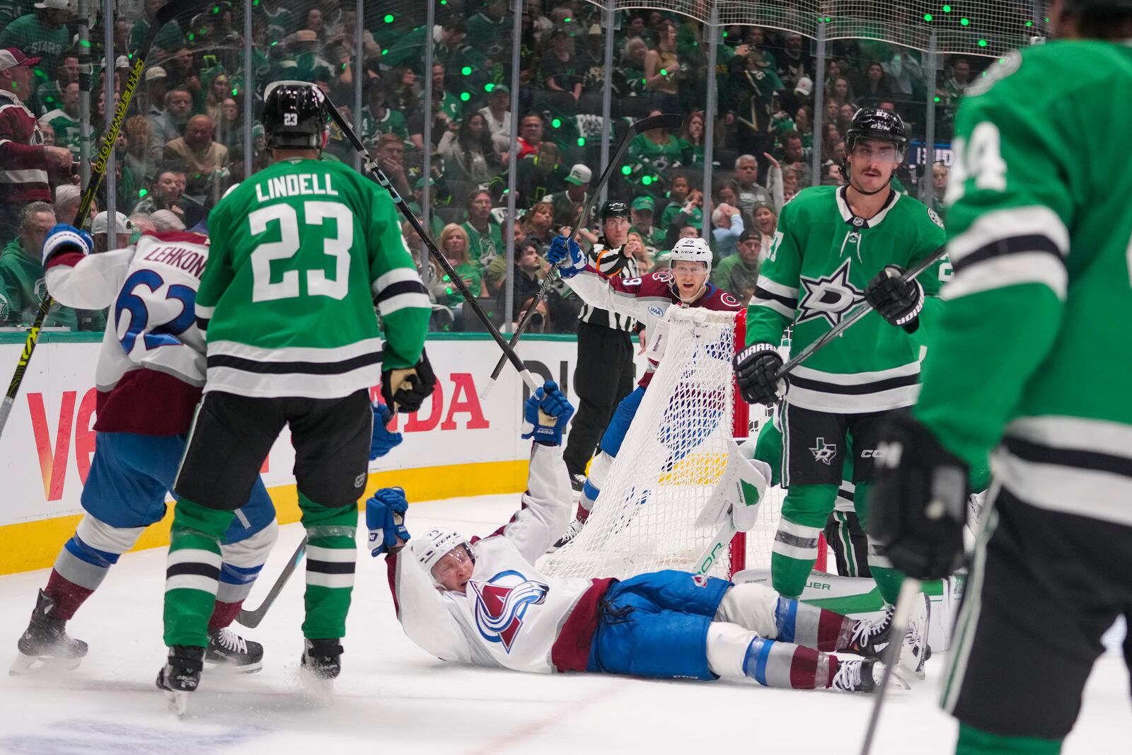 Colorado Avalanche right wing Logan O'Connor, bottom, reacts after scoring a goal against the Dallas Stars during the second period in Game 2 of a first-round NHL hockey playoff series Monday, April 21, 2025, in Dallas. (AP Photo/Julio Cortez)