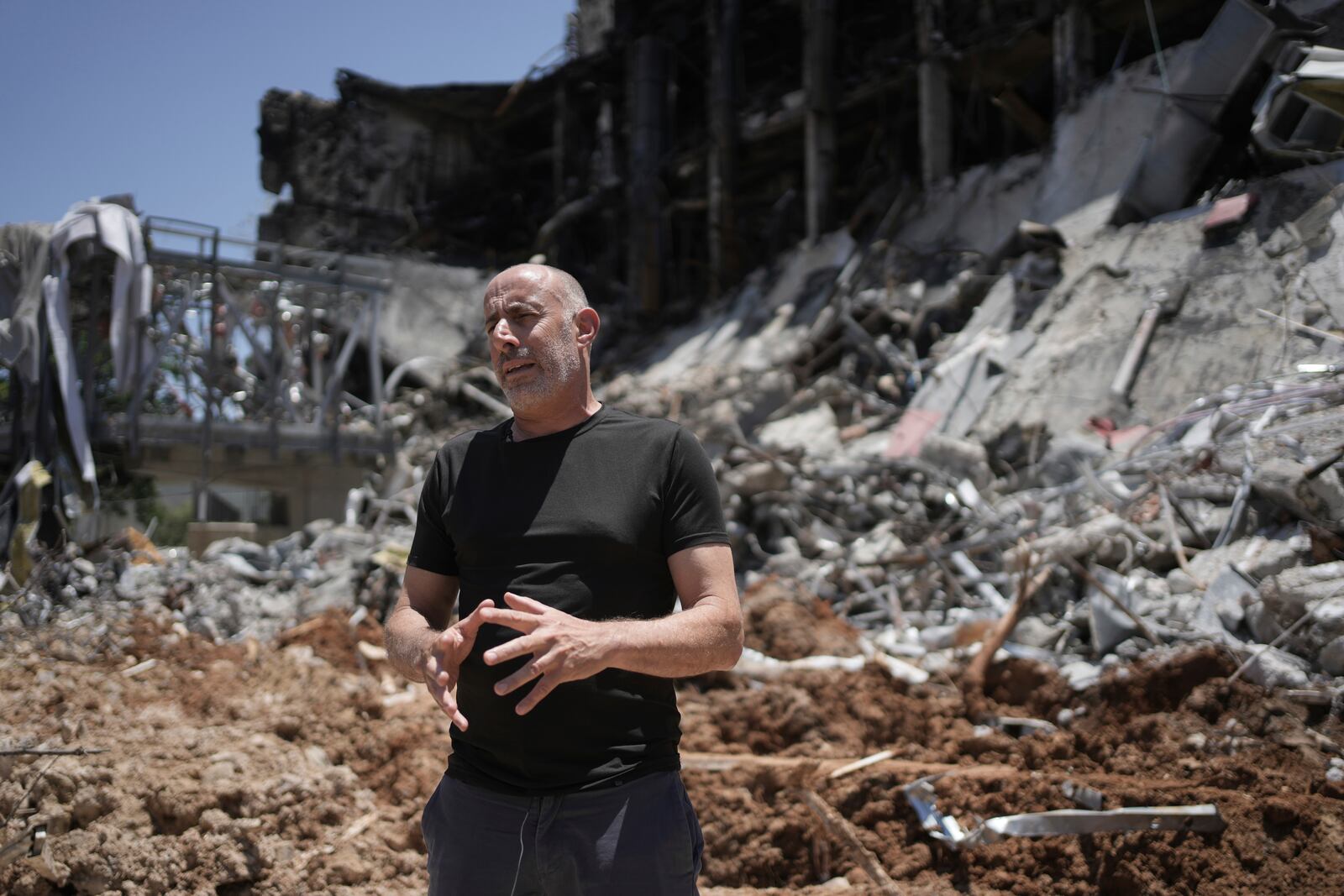 Professor Ori Ozeri speaks in front of damage to the Weizmann Institute of Science from an Iranian missile strike in Rehovot, Thursday, June 19, 2025. (AP Photo/Maya Alleruzzo)