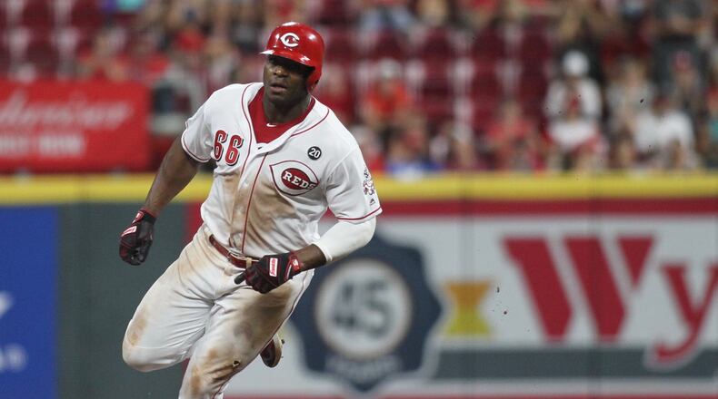The Reds Yasiel Puig rounds the bases on his way to scoring the winning run in the 11th inning against the Brewers on Tuesday, July 2, 2019, at Great American Ball Park in Cincinnati. David Jablonski/Staff