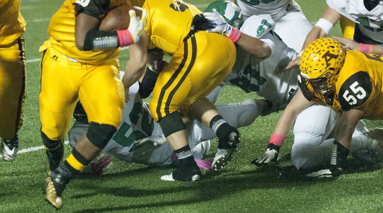 Alter’s Lamar Landers runs against the Chaminade Julienne defense during Friday night’s game at Rausch Stadium. Jeff Gilbert/CONTRIBUTED