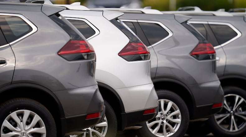 A long line of unsold SUVs sits at a dealership. (AP Photo/David Zalubowski)