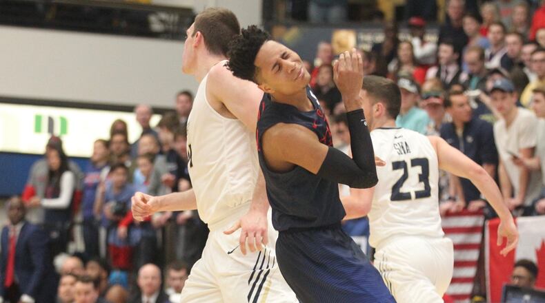 Dayton's Darrell Davis runs into a screen by George Washington's Tyler Cavanaugh in the first half on March 4, 2017, at the Smith Center in Washington, D.C.