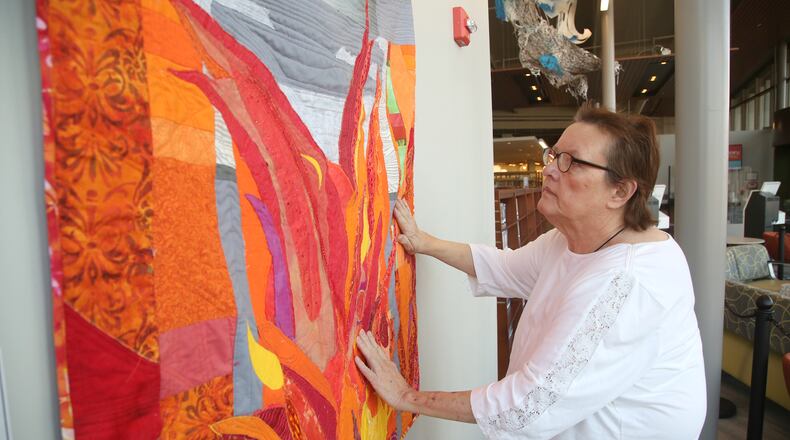 Cathy Jeffers, a Centerville fiber artist, has organized an art exhibition, The Climate Awareness Project, at the Woodbourne Library in Centerille. Dayton-area artists have created their interpretations of environmental concerns for the planet. LISA POWELL / STAFF