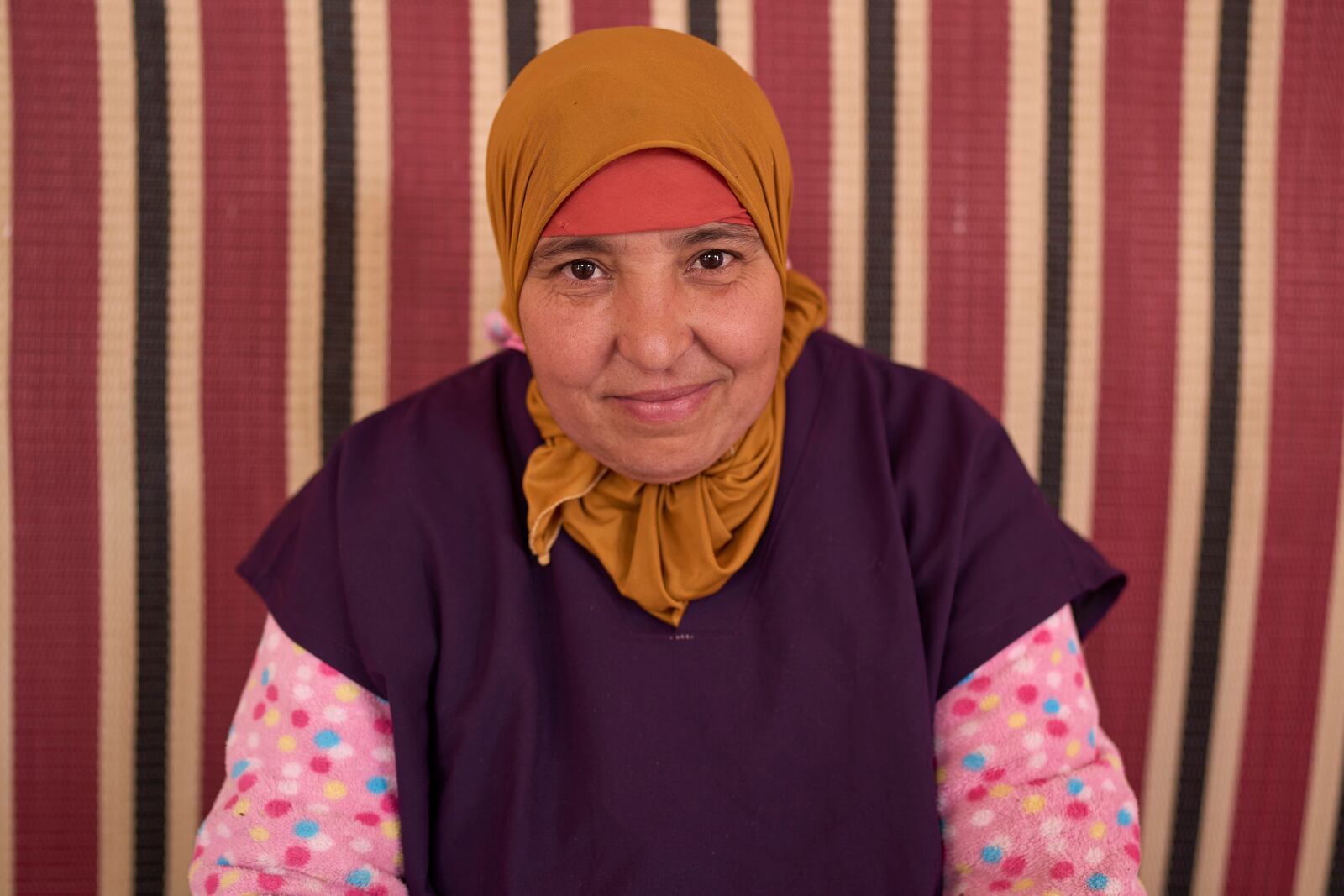 Rabiaa Reshmayn, who works at a cooperative that extracts and produces argan oil and products, poses for a portrait, in Essaouira, Morocco, Thursday, May 22, 2025. (AP Photo/Mosa'ab Elshamy)