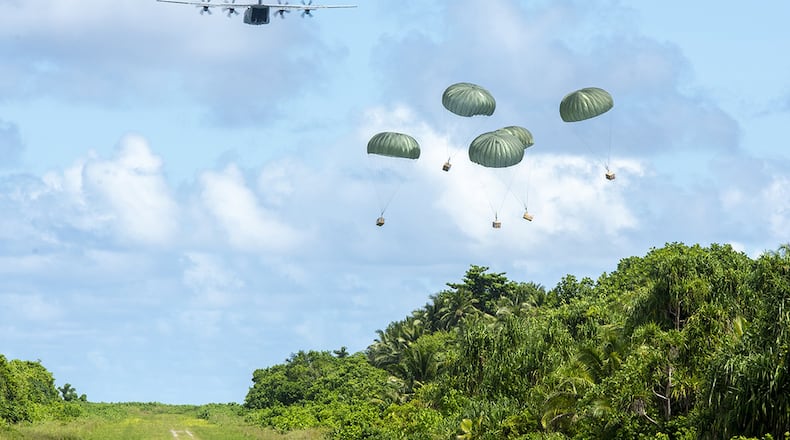 A U.S. Air Force C-130J Super Hercules out of Yokota Air Base, Japan, delivers five low-cost, low-altitude humanitarian aid bundles filled with critical supplies as part of Operation Christmas Drop to the island of Woleai, Federated States of Micronesia, Dec. 10. In its 68th year, Operation Christmas Drop is the world’s longest-running airdrop training mission, providing critical supplies to 55 remote Micronesian islands like Woleai, impacting approximately 20,000 people across 1.8 million square nautical miles of operating area. (U.S. Air Force photos/Senior Airman Matthew Gilmore)