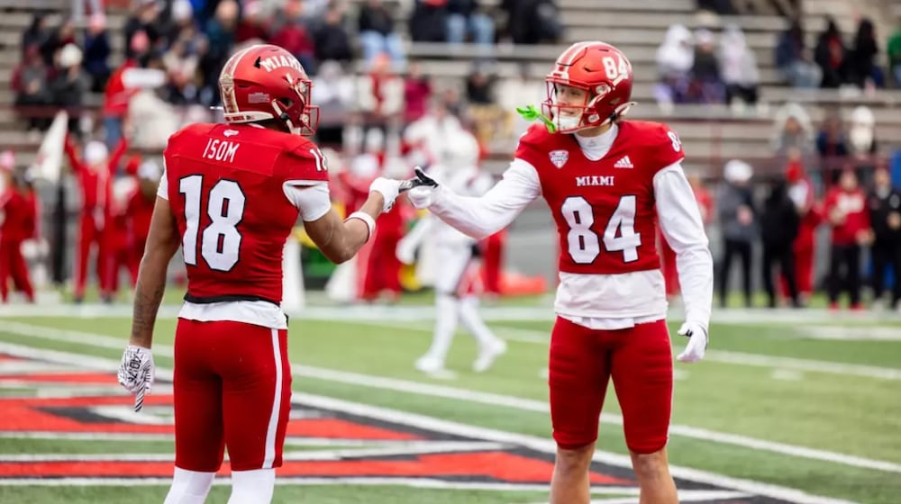 Miami's Braylon Isom (18) and Cole Weaver (84) celebrate after Isom caught a touchdown pass against Ball State on Saturday, Nov. 29, at Yager Stadium. JEFFREY SABO / MIAMI ATHLETICS