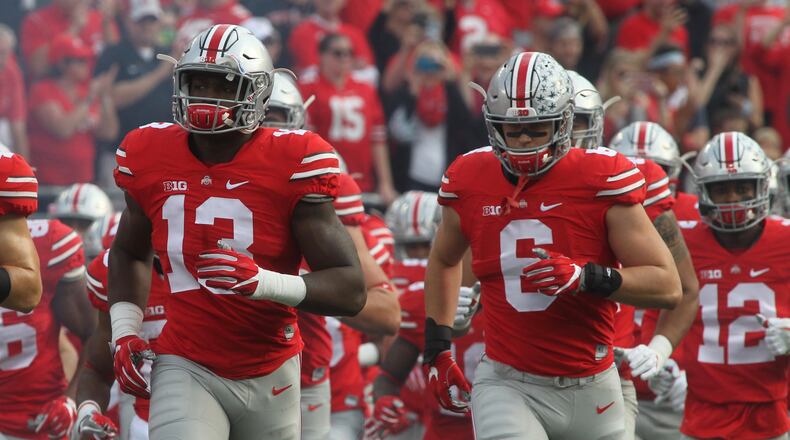 Ohio State players take the field against Northwestern. David Jablonski/Staff