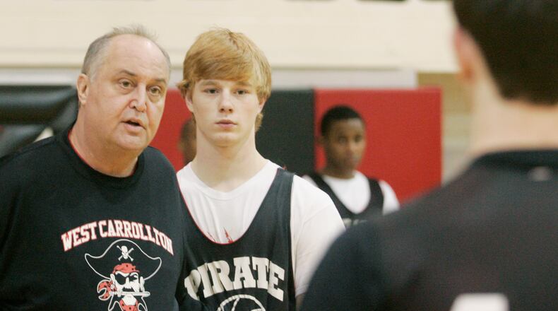 Dan Gerhard (left) is shown in this photo in 2011, when he was head coach of the West Carrollton boys basketball team, a title he held for more than 25 years. FILE PHOTO