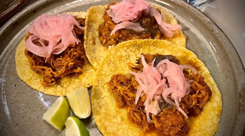 Tacos de Cochinita from Sueño featuring adobo marinated pork, salsa tamulado and pickled red onions. NATALIE JONES/STAFF