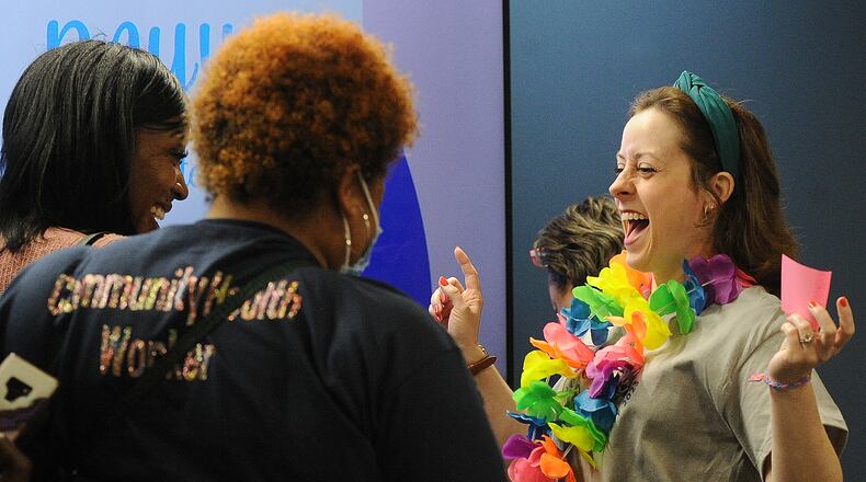 Katie Gainey-West, Director of Dayton Regional Pathways HUB, right, greets community health workers, Dorinda Hill, left, and Britany Smith at the Community Health Workers celebration, Tuesday June 6, 2023 at GDAHA office in Dayton. MARSHALL GORBY\STAFF