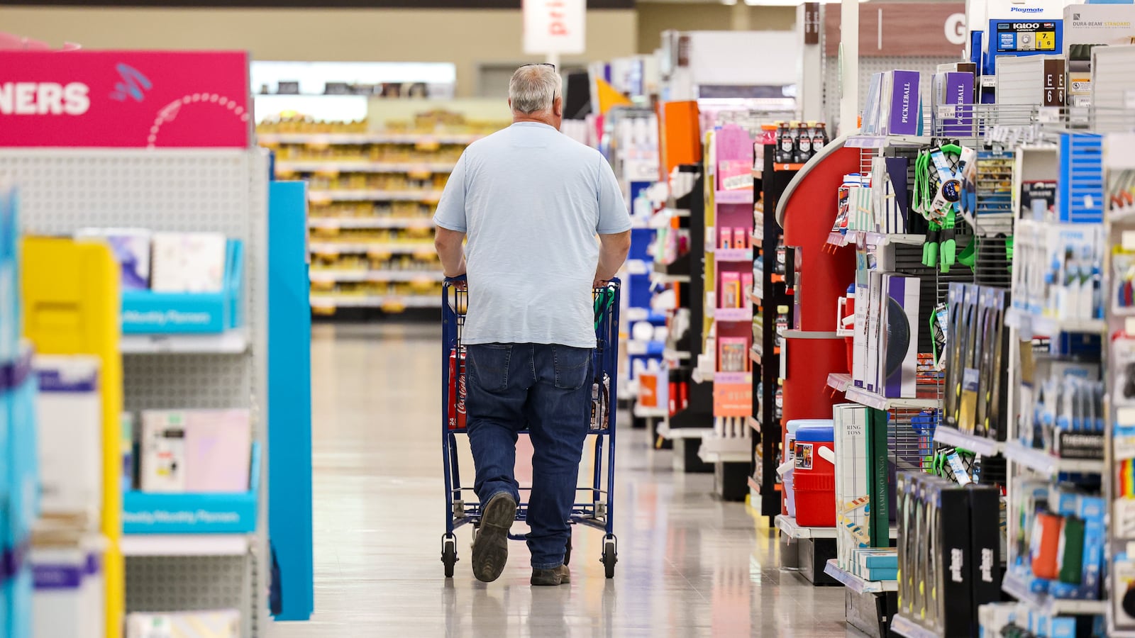 A shopper at Meijer on Springboro Pike pushes a cart down an aisle on Friday, July 25. Ohio’s extended two-week sales tax holiday, running Aug. 1–14, lets shoppers skip the tax on most items under $500, including electronics, clothing, furniture and even food, both in stores and online. BRYANT BILLING / STAFF