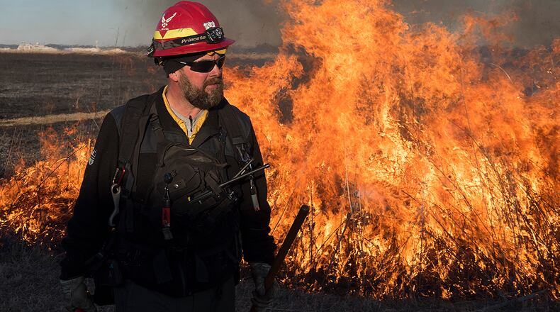 Darryn Warner, 88th Civil Engineering Group Natural Resource Program manager, stands in front of a prescribed burn on Huffman Prairie Feb. 21, 2020. Warner coordinated and oversaw the burn which was used to help the native prairie grass grow. U.S. AIR FORCE PHOTO/R.J. ORIEZ