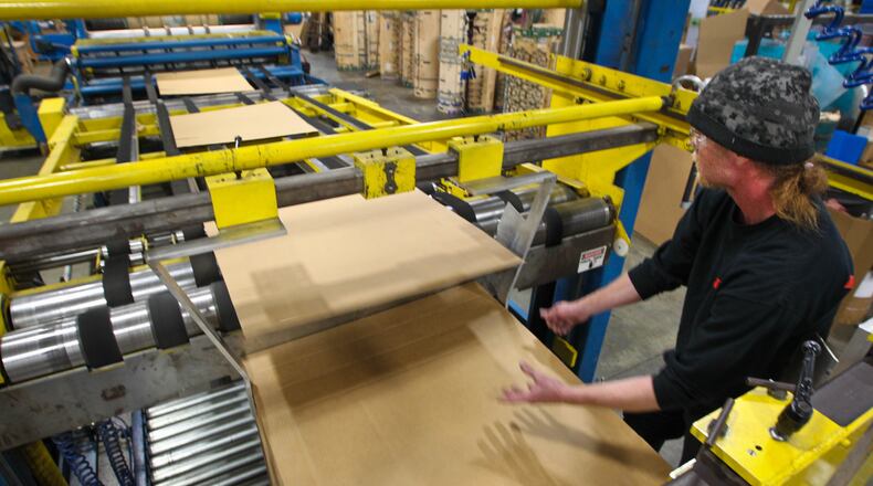 Operator Doug Coleman runs the rotary die cutting machine that custom prints and cuts boxes for customers at Value Added Packaging in Clayton. STAFF