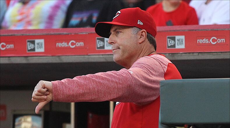 Reds manager Bryan Price motions to the umpires that he won't call for a review of a play at first base against the Brewers on Tuesday, June 27, 2017, at Great American Ball Park in Cincinnati. David Jablonski/Staff