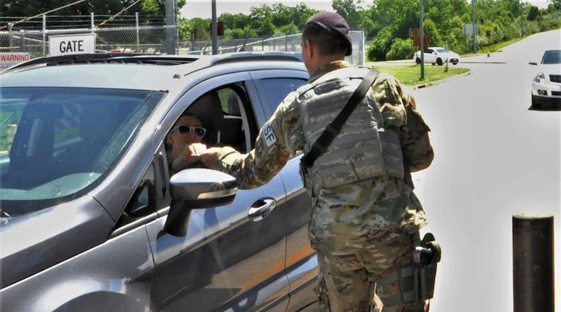 Senior Airman Andrew Richardson welcomes a patron through Gate 15A June 12 at Wright-Patterson Air Force Base. Often, the entry controllers are the first to greet those coming onto the base at the start of their day. (U.S. Air Force photo/Caroline Clauson)