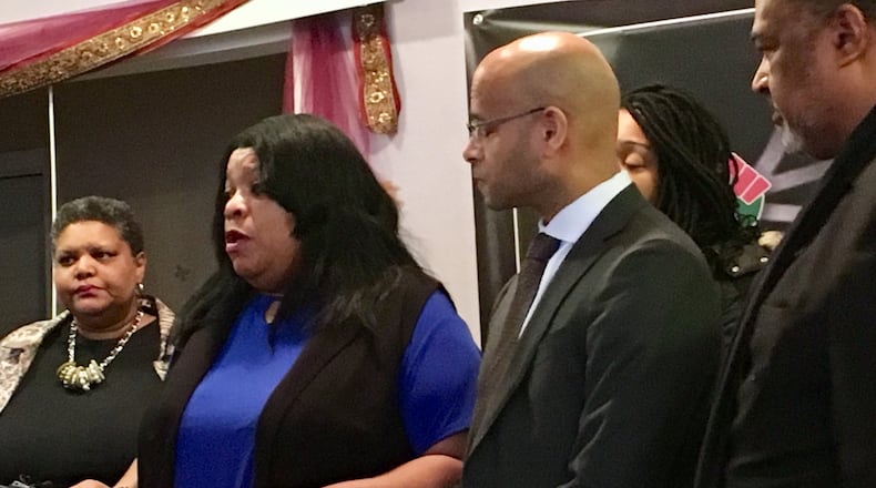 Sabrina Jordan (second from left), the mother of Jamarco McShann, speaks during Wednesday’s press conference about the wrongful death lawsuit filed in Dayton’s U.S. District Court. McShann was shot and killed last year by Moraine police, who said McShann did not respond to messages to drop a weapon. McShann had been asleep in his car. To Jordan’s left is her attorney, Andrew Stroth. STAFF/MARK GOKAVI