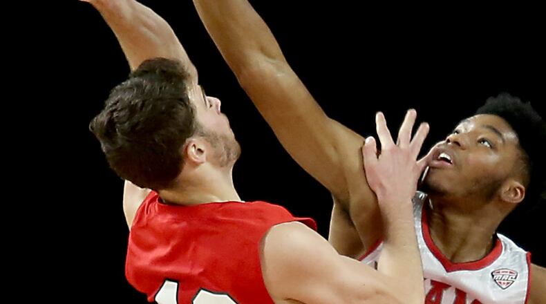 Contributed photo by E.L. Hubbard Miami forward Marcus Weathers blocks the shot of Olivet forward R.J. Haas during their game at Millett Hall in Oxford Thursday, Dec. 29, 2016.