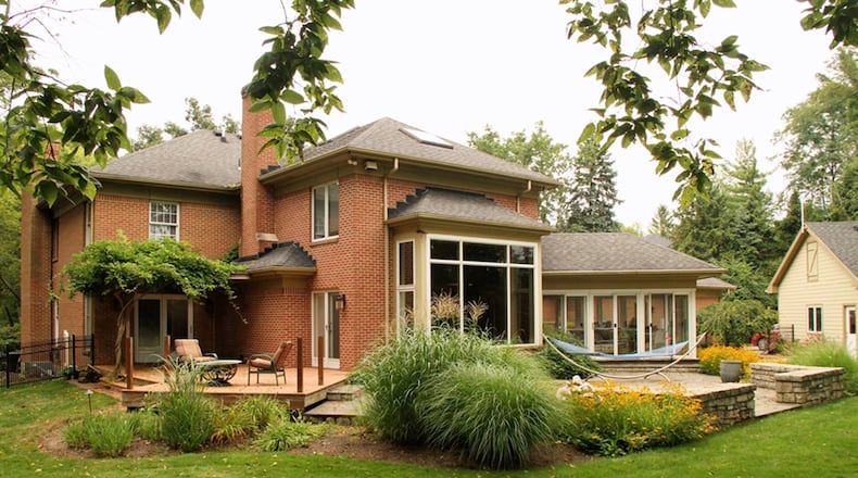 Patio doors open off the first-floor bedroom out to a composite deck. A 4-season room provides panoramic views of the semi-private back yard. The unfinished basement walks out to the rear deck. The property has a detached, 2-car garage.