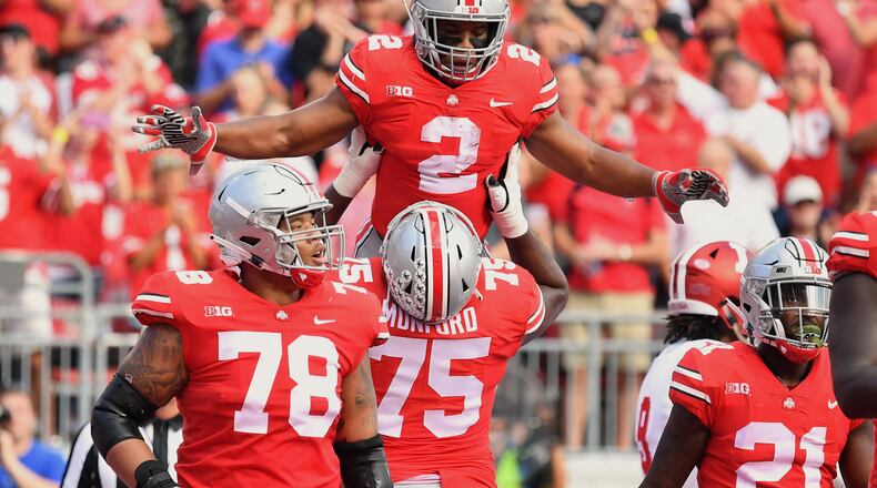 COLUMBUS, OH - OCTOBER 6: J.K. Dobbins #2 of the Ohio State Buckeyes celebrates his first quarter touchdown run against the Indiana Hoosiers with Thayer Munford #75 of the Ohio State Buckeyes at Ohio Stadium on October 6, 2018 in Columbus, Ohio. (Photo by Jamie Sabau/Getty Images)