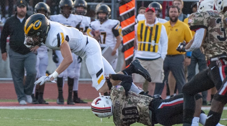 Centerville quarterback Chase Harrison is tackled by Wayne’s Leo Howard in the first half of Friday’s game at Wayne. Jeff Gilbert/CONTRIBUTED