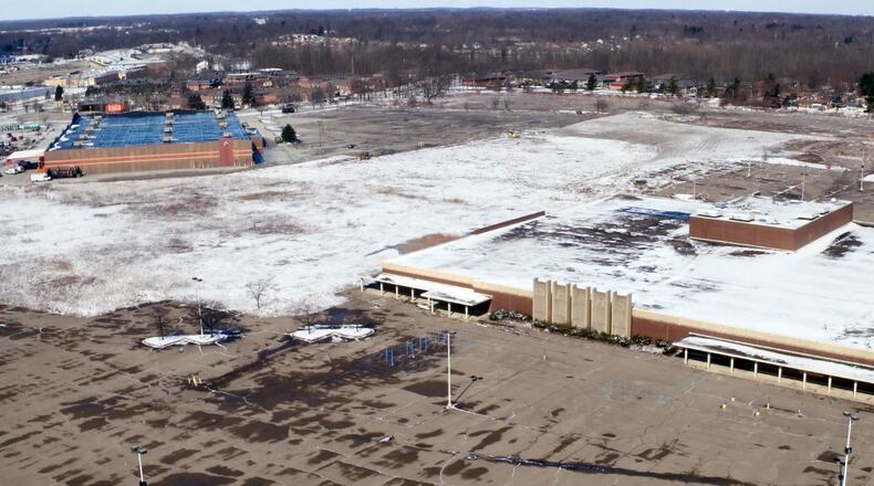The footprint of the former Salem Mall is covered in snow after clearing and grading of the land was performed in the past week. The old Sears store, right, is all that remains on the site. TY GREENLEES / STAFF