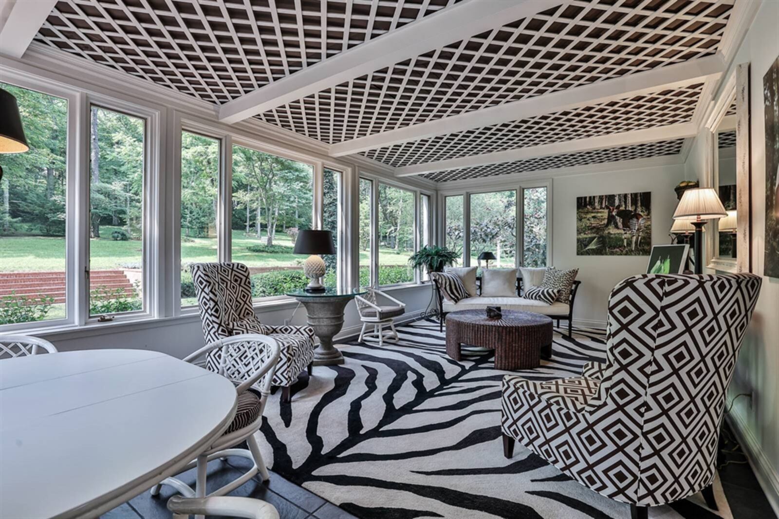 The four-season room has heated ceramic-tile flooring and a wood lattice ceiling. Contributed
