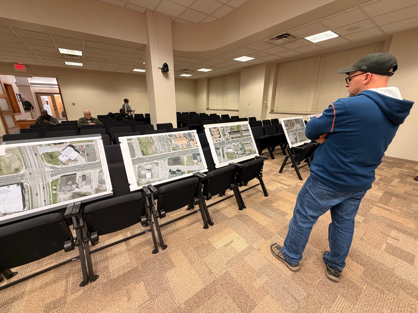 Joel Michael, of Dayton, looks over maps of proposed projects in the west side of town that hope to calm traffic on West Third Street and Gettysburg Avenue. SYDNEY DAWES/STAFF