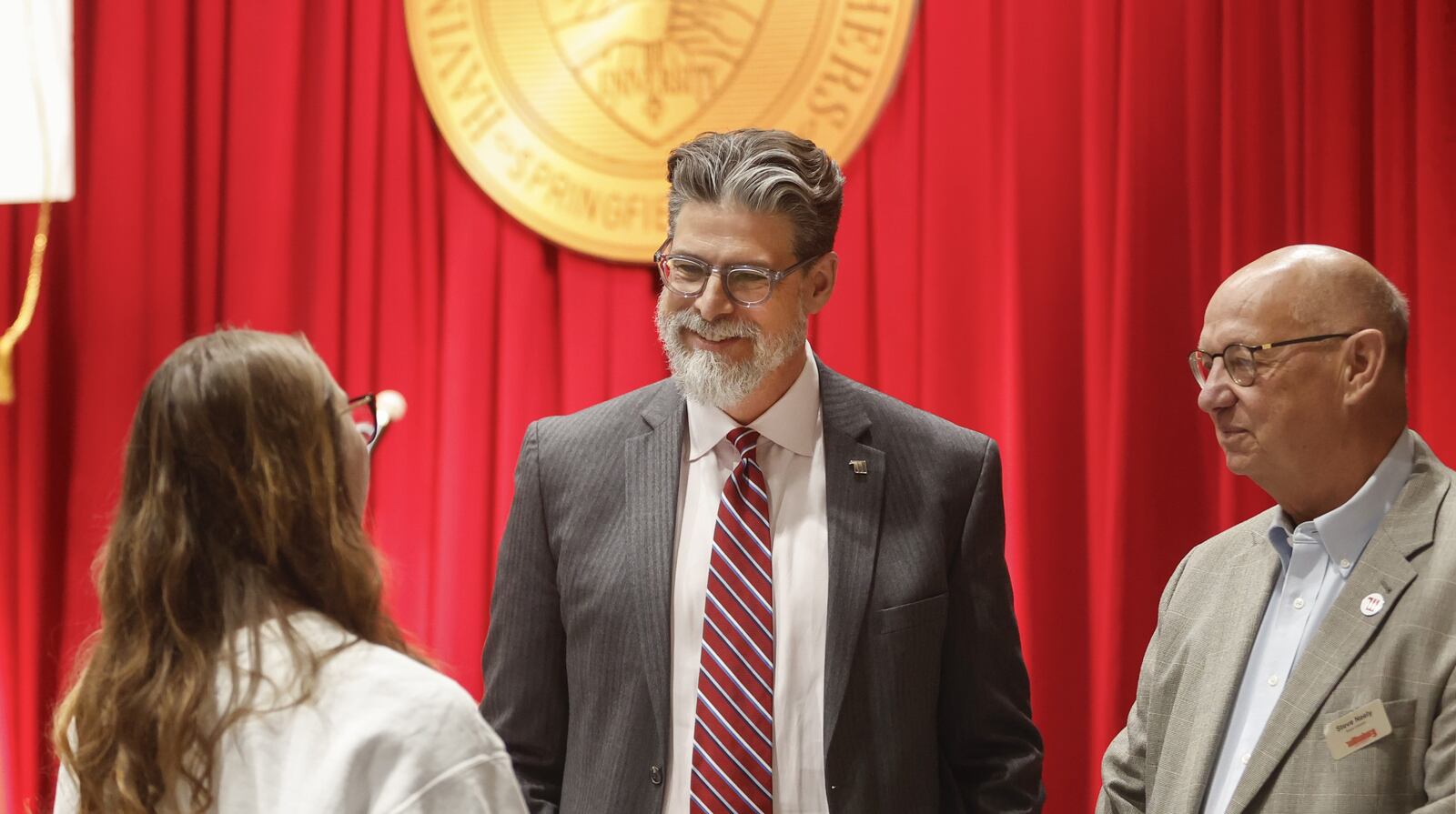 New Wittenberg University President Christian Brady, center, and board member Steve Neely, right, talk to Victoria Pipinich on Friday, May 9, 2025. JOSEPH COOKE / STAFF
