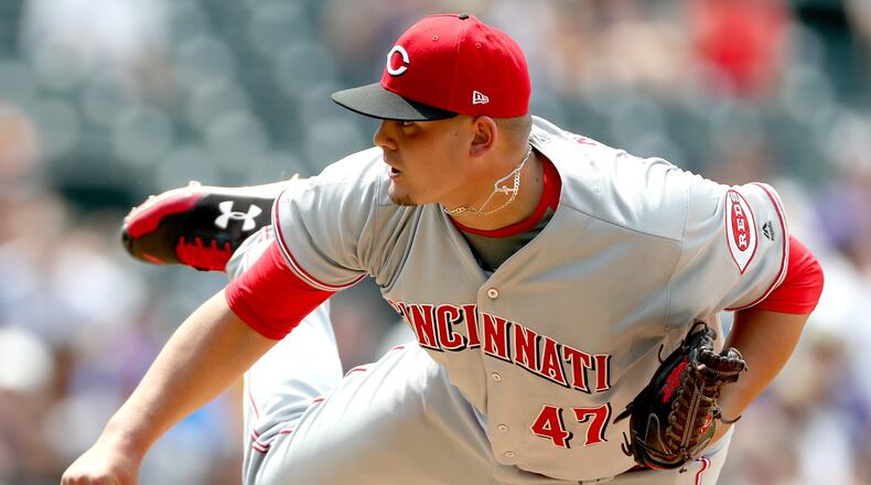 Reds starting pitcher Sal Romano throws in the fifth inning against the Rockies at Coors Field Thursday on the way to picking up his first career MLB win.