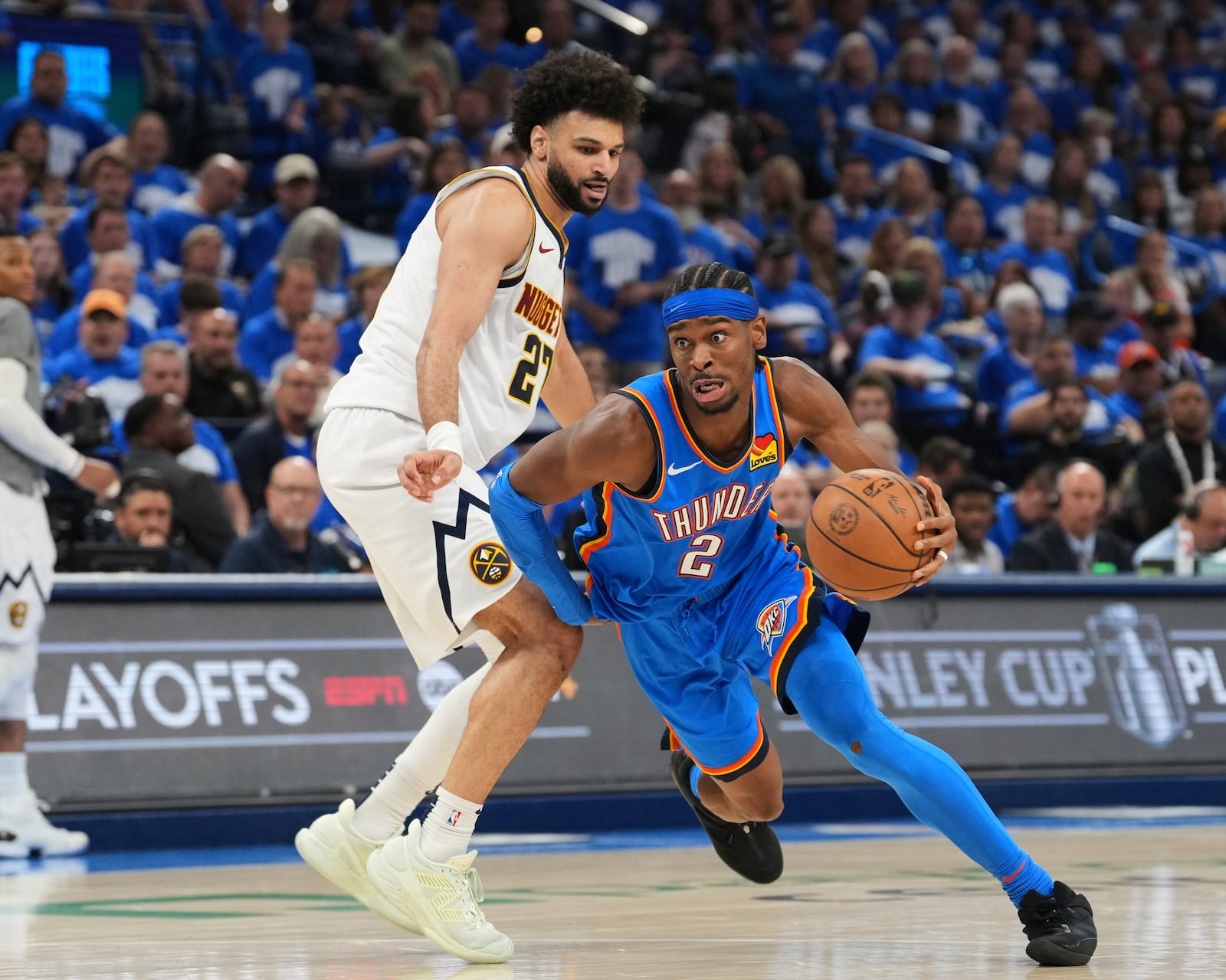 Oklahoma City Thunder guard Shai Gilgeous-Alexander (2) works to the basket against Denver Nuggets guard Jamal Murray, left, in the second half of Game 7 in the Western Conference semifinals of the NBA basketball playoffs, Sunday, May 18, 2025, in Oklahoma City. (AP Photo/Kyle Phillips)