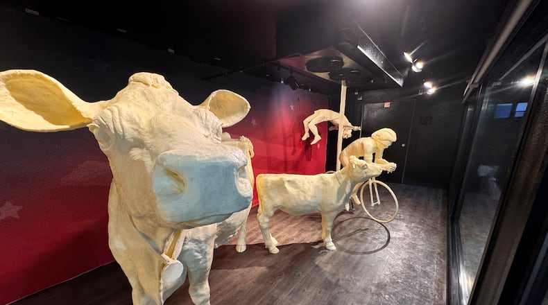 The traditional butter cow and calf are sporting butter medallions in this year’s butter display at the Ohio State Fair (CONTRIBUTED PHOTO).