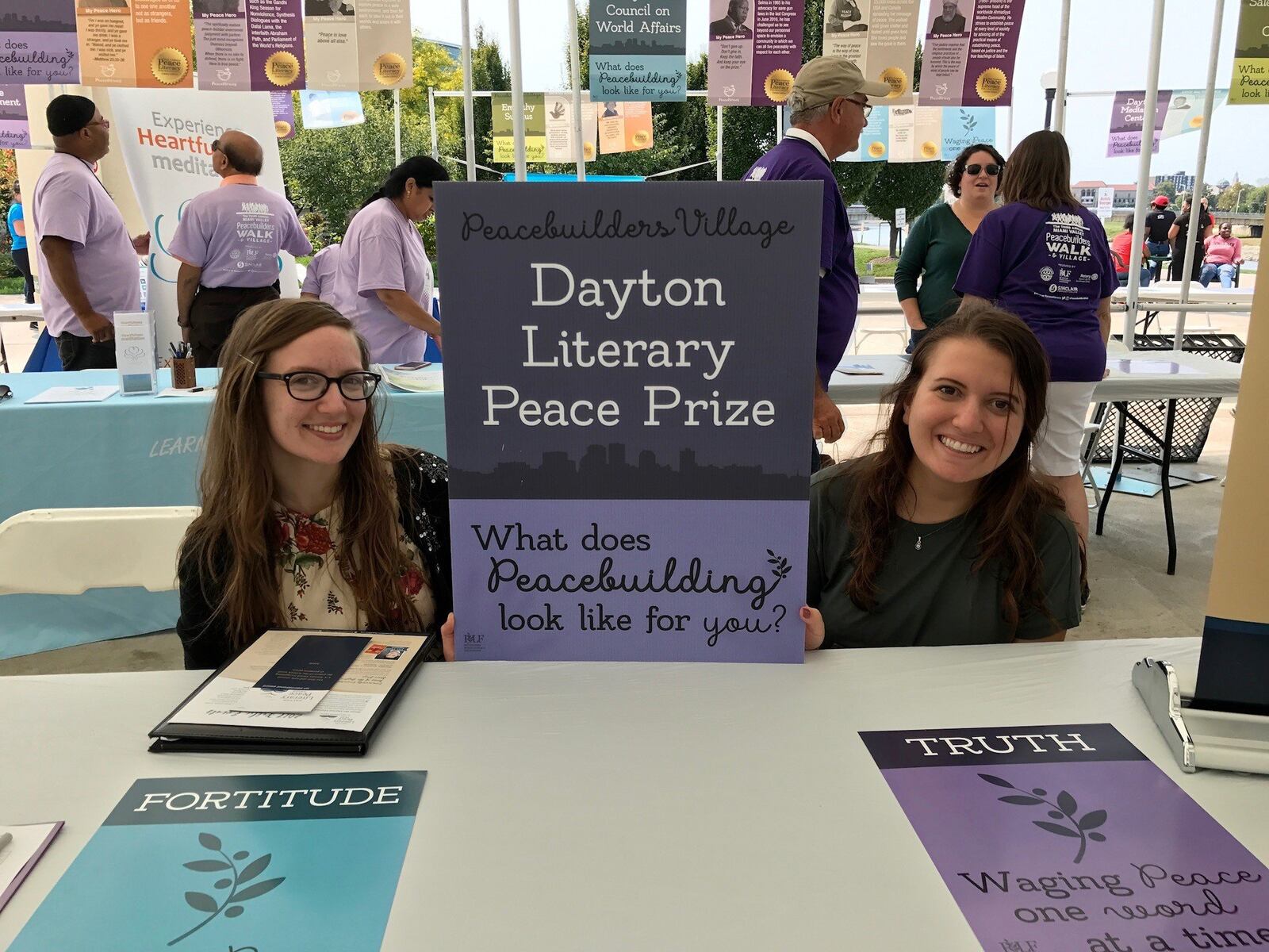 Dayton Literary Peace Prize administrative assistant Emily Kretzer (left) and University of Dayton intern, Karen Naim put the spotlight on the prize in this file photo. SUBMITTED PHOTO BY ANDY SNOW