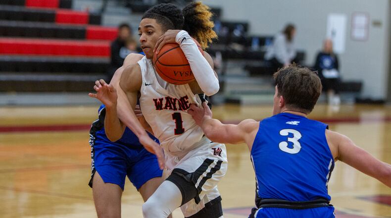 Wayne's Lawrent Rice drives between Springboro's Jaden Brown (3) and another defender during Friday night's game at Wayne. Rice had 15 points and 10 assists in a 61-40 victory. Jeff Gilbert/CONTRIBUTED