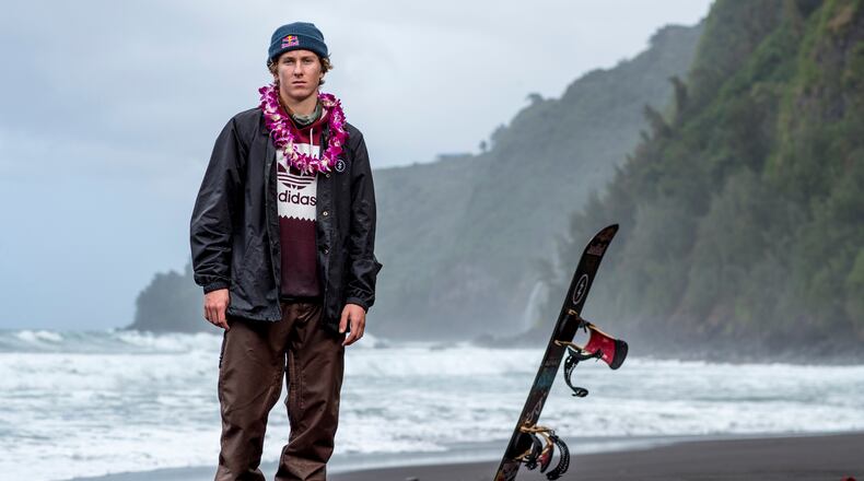 In this Feb. 21, 2017, photo provided by Red Bull, Lyon Farrell poses on a beach in Waipo Valley on the island of Hawaii. Farrell grew up skateboarding and surfing in Hawaii before a visit to New Zealand introduced him to snowboarding. Ever since, he's preferred landing triple corks to hanging 10 as he sets his sights on making the U.S. slopestyle squad for the Olympics next winter in South Korea. (Zak Noyle/Red Bull via AP)