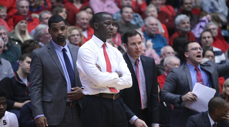 Dayton coaches Ricardo Greer, Anthony Grant, James Kane and Andy Farrell watch the action during a game against Georgia State on Saturday, Dec. 16, 2017, at UD Arena. David Jablonski/Staff