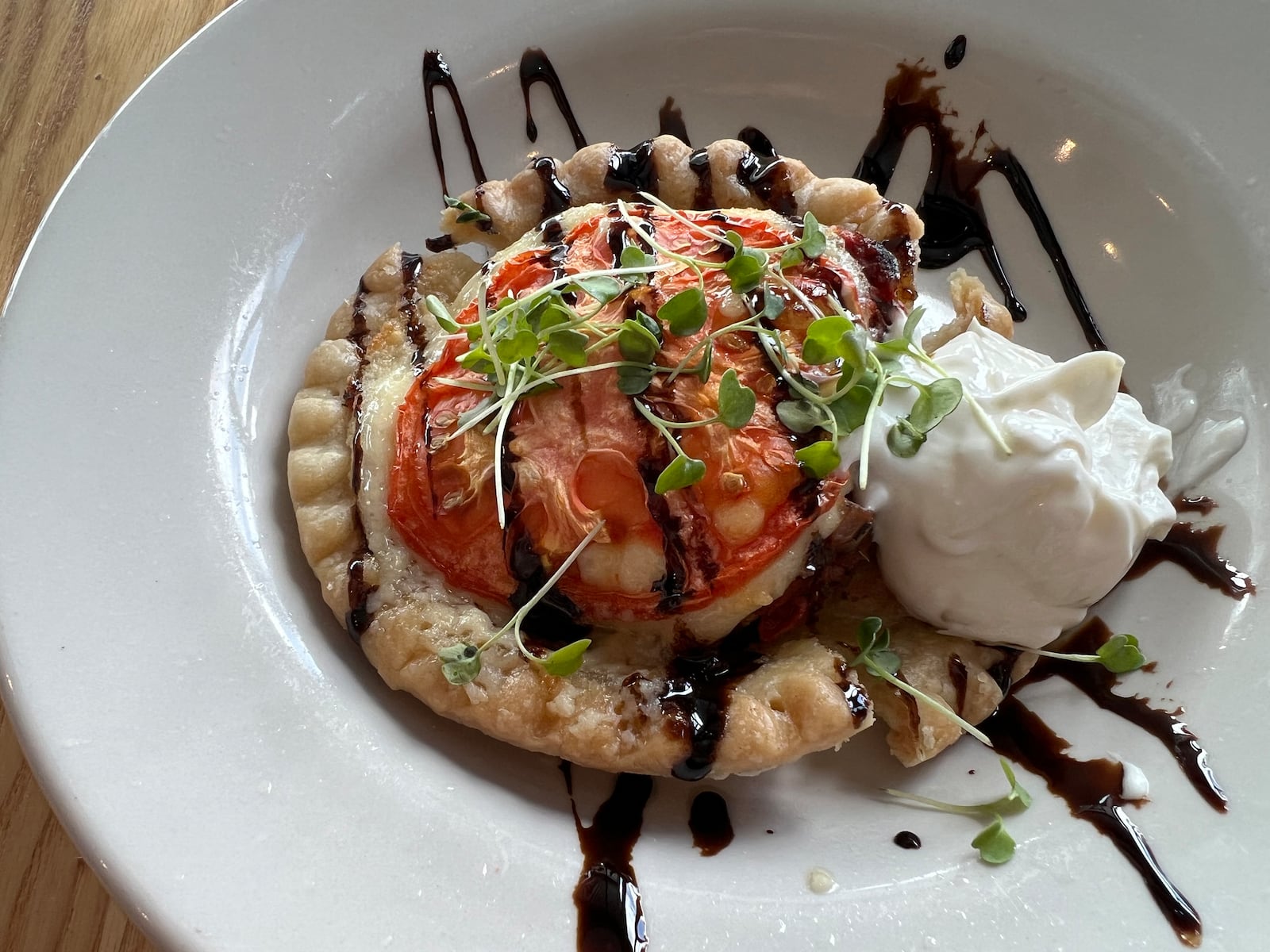 The Indiana Tomato Pie at Upland Brewing in Jeffersonville, just over the Ohio River from Louisville, Kentucky, is a flavorful concoction of summer tomatoes, parmesan cheese, sour cream, chives and balsamic syrup. Try it with one of Upland's craft beers, sour ales or seasonal brews. MARY ANN ANDERSON/TRIBUNE NEWS SERVICE