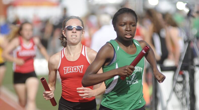 Northmont’s Melissa Barrett (right) takes a slight lead over Troy’s Morgan Gigandi in the 4x800 relay during the D-I district track and field meet at Wayne High School on Wednesday, May 17, 2017. MARC PENDLETON / STAFF