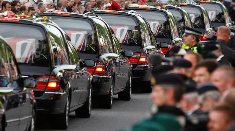 FILE - The coffins of seven British soldiers killed in Afghanistan, are driven through the town of Wootton Bassett, England, after repatriation to Britain, Tuesday, June 29, 2010. (AP Photo/Lefteris Pitarakis, file)