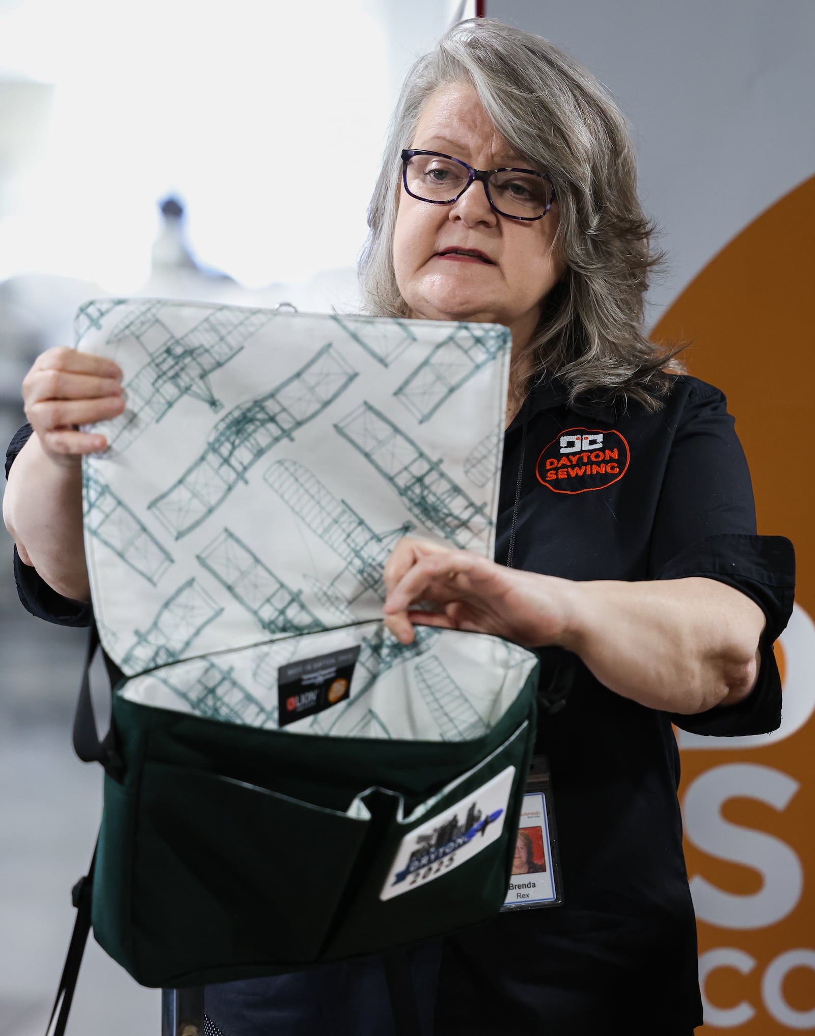 Brenda Rex, the director of the Dayton Sewing Collaborative, shows a bag that will be given to NATO Parliamentary Assembly Spring Session participants in May. The collaborative designed and is producing the bags. The bags were unveiled at a news conference on Monday at the collaborative's space in Goodwill Easter Seals Miami Valley main campus. BRYANT BILLING / STAFF