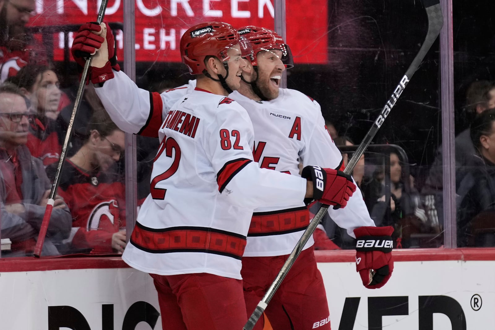 Carolina Hurricanes' Jaccob Slavin, right, celebrates his goal with Jesperi Kotkaniemi during the first period of Game 4 of an NHL hockey first-round series against the New Jersey Devils, Sunday, April 27, 2025, in Newark, N.J. (AP Photo/Seth Wenig)